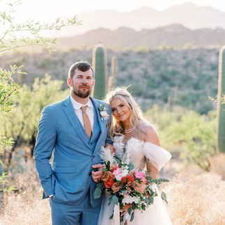 Bride and groom portrait among saguaro cacti at Tanque Verde Ranch wedding