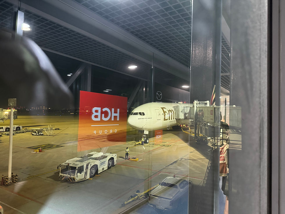 Catching a glimpse of our Emirates B777 plane before boarding at Phnom Penh International Airport