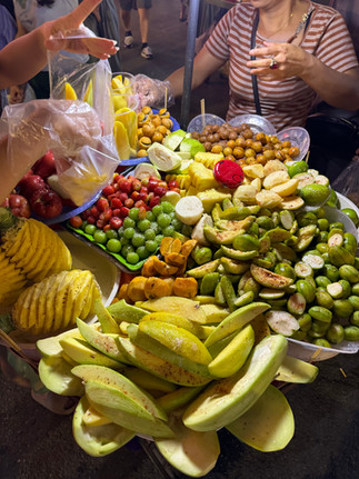 Checking out the street food vendor selling cut fruits at Hoan Kiem Lake