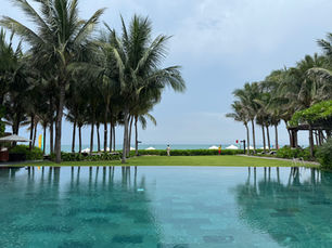 Main swimming pool at The Anam Mui Ne overlooking the beachfront and the South China Sea in Mui Ne, Vietnam.