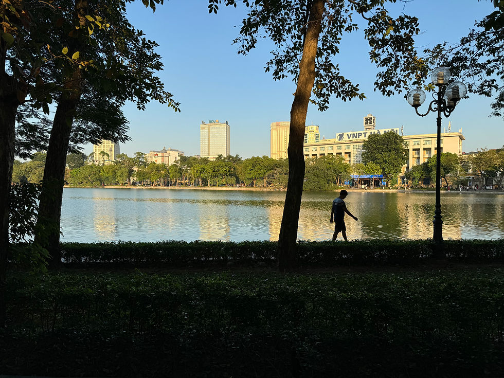 Hoan Kiem Lake in Hanoi Vietnam with locals exercising in the morning