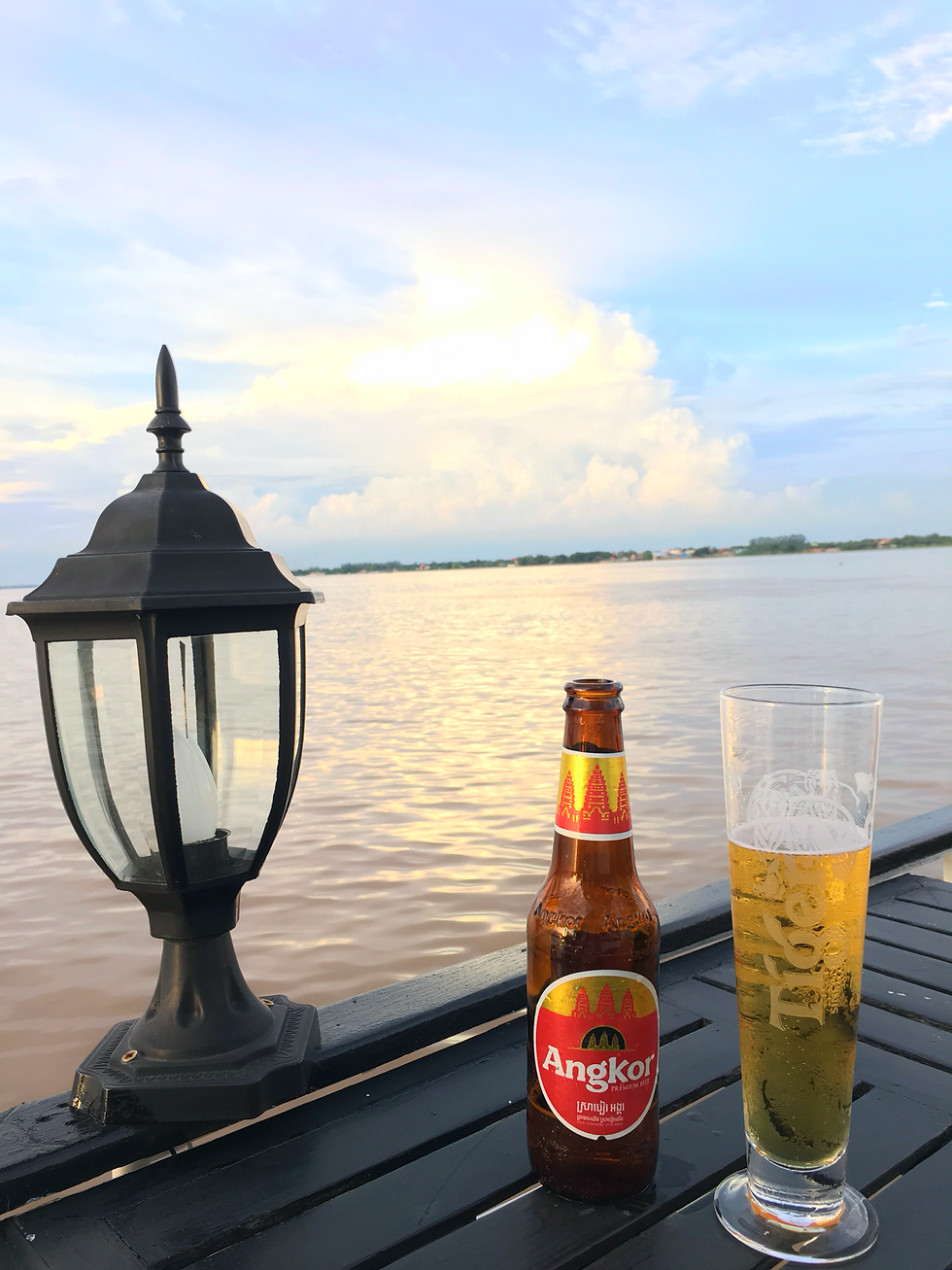 Enjoying a beverage while sailing along the Tonle Sap