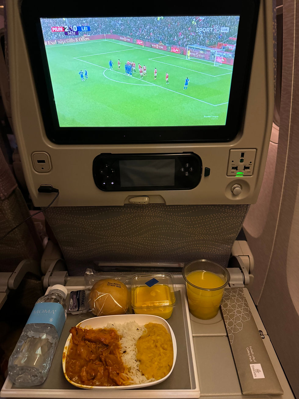 Enjoying our delicious dinner on board our Emirates flight