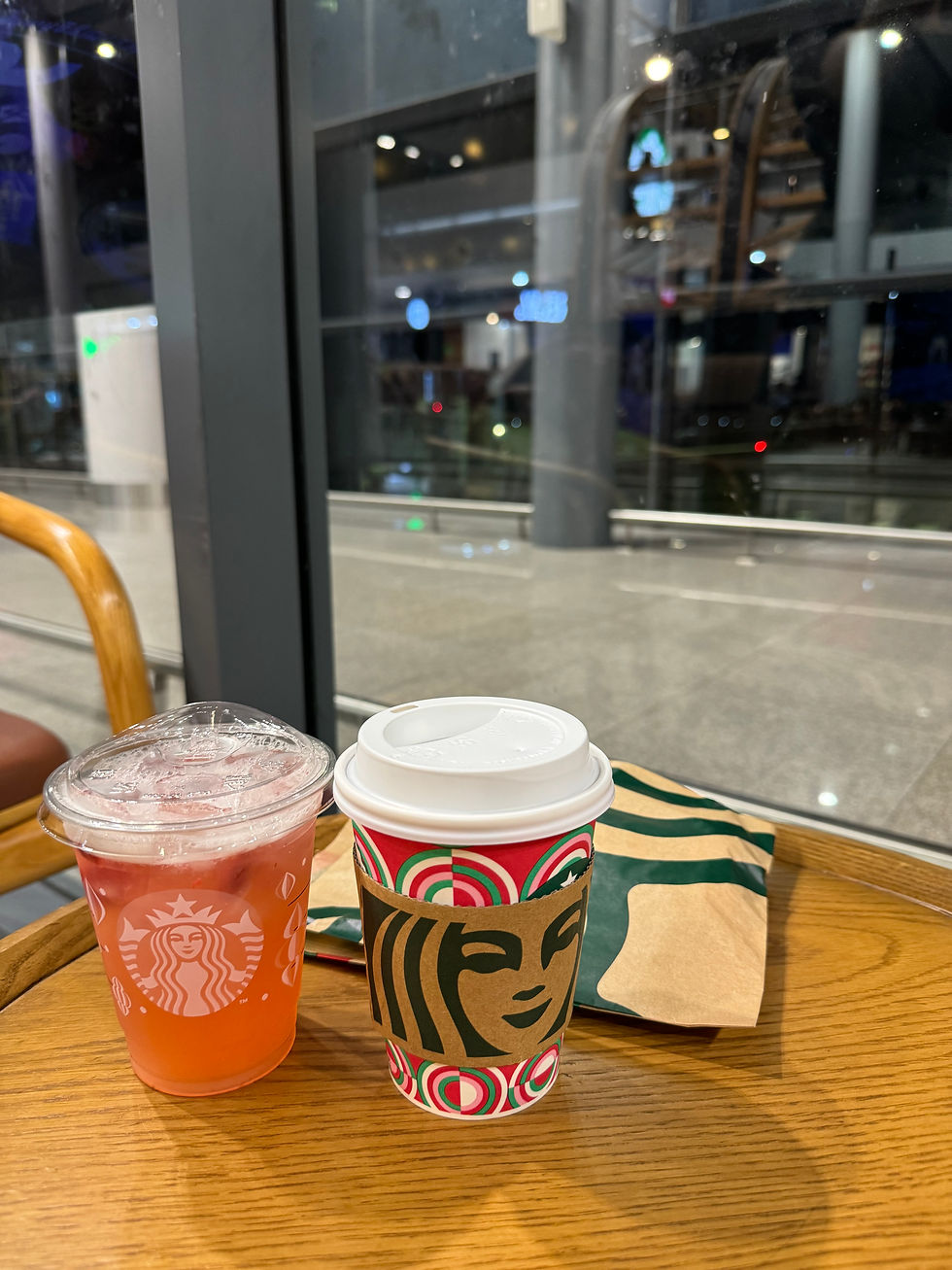 Enjoying our final Starbucks drinks at Phnom Penh International Airport
