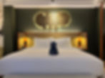 King bed in TRIBE Comfort XL room at TRIBE Bali Kuta Beach with signature wall art and soft lighting
