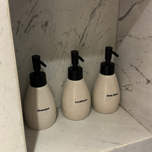 Shampoo, conditioner and body wash provided in the shower at Signature by M Village Hai Bà Trưng.