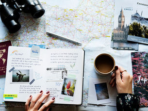 Travel planning flat lay with map, journal, passport and coffee representing a long-term goal to visit every Southeast Asian country by 2030