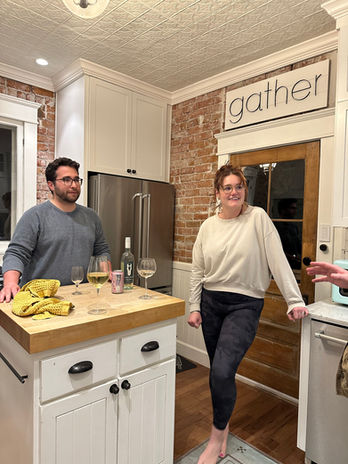 Two people in cozy kitchen with