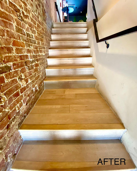 Staircase leading upstairs at former Kitsuen restaurant on H Street, DC, featuring modern design and wood accents complementing the light beige hardwood flooring
