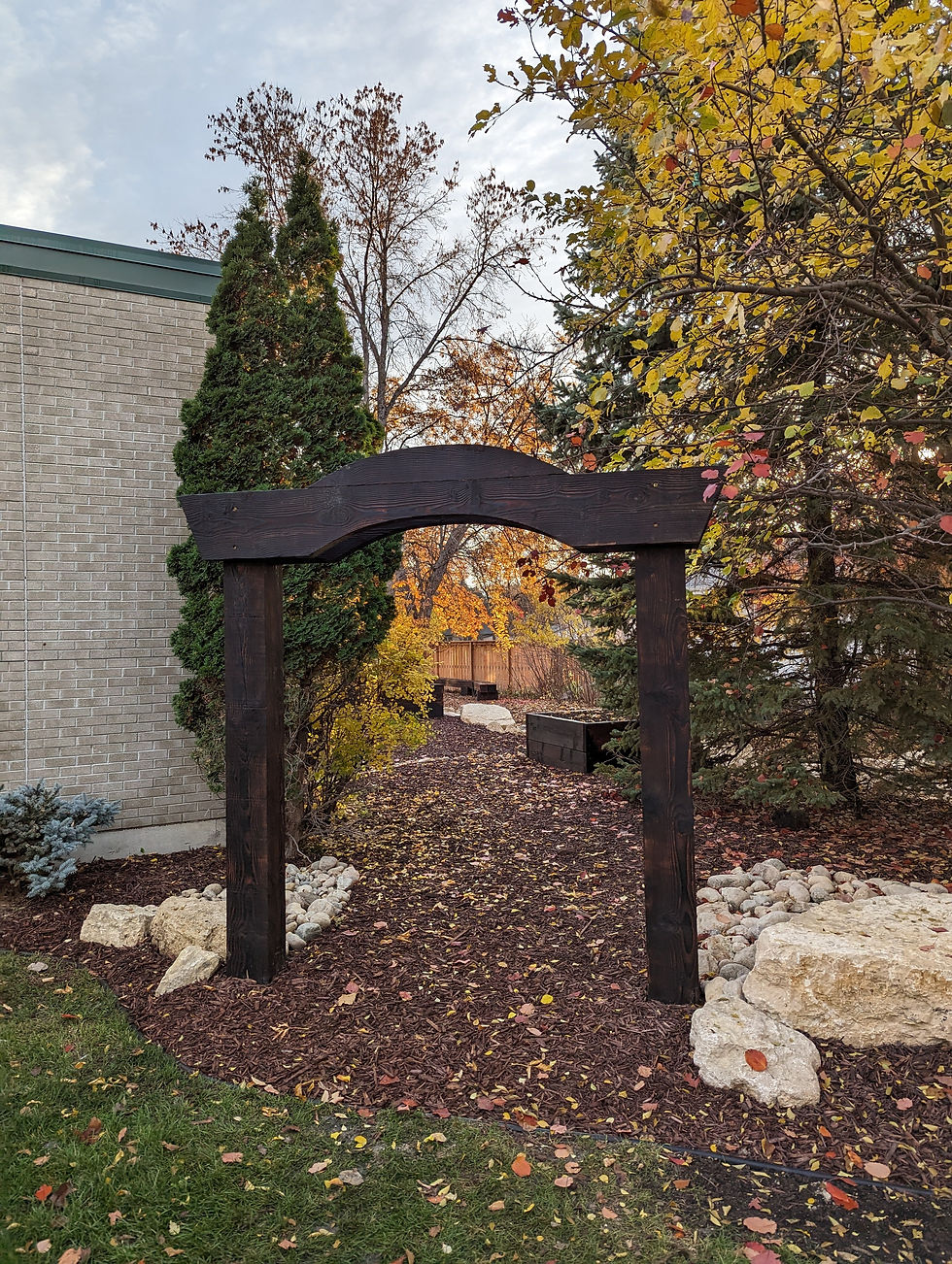 A wooden arbor leading into Katherine's Garden.