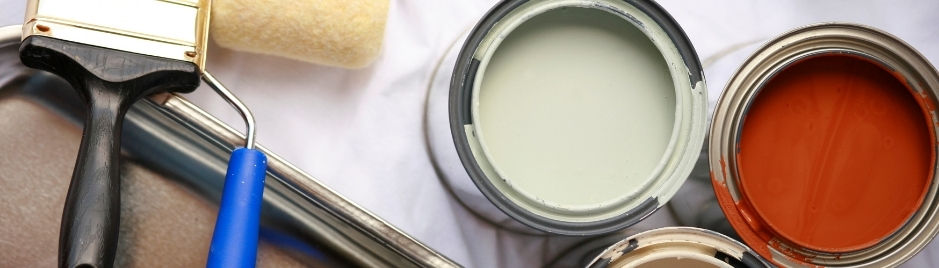 An accent image of paint cans filled with various colors of paint, as seen from above