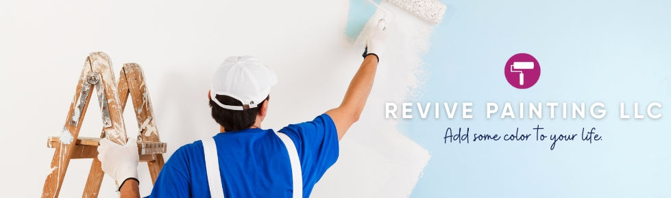 A painter is rolling white paint across a light blue wall. The Revive Painting logo overlays the image.