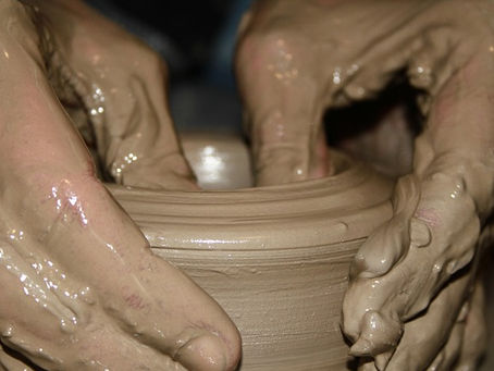hands doing pottery