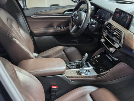 "Side-by-side comparison showing the meticulous exterior and wheel detailing results of a 9-hour deep clean on a black BMW X4."
