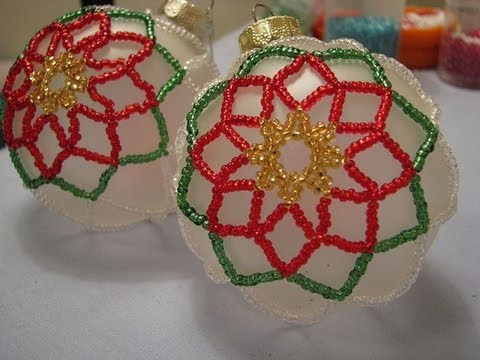 2" round ornaments surrounding with a Poinsettia design in gold, red, and green beads.