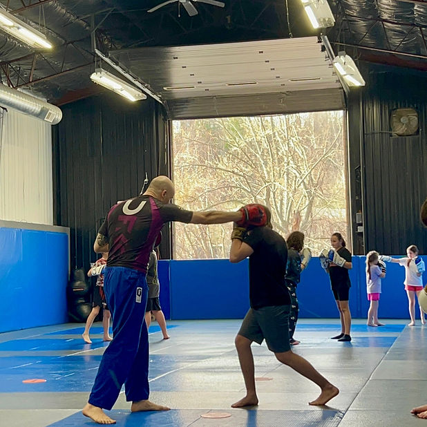 Children practicing kickboxing techniques during a youth martial arts class at Broome County Martial Arts in Binghamton, NY.