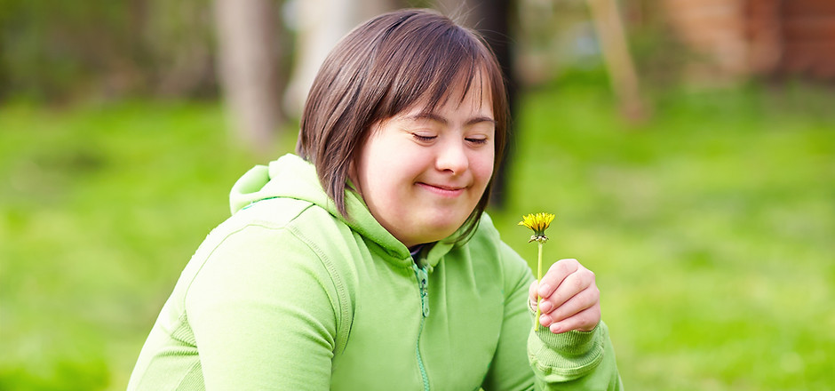 young adult woman with disability enjoying nature in spring garden