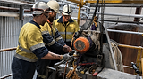 Omega_Workers with machine.png