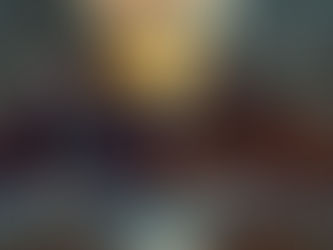 Couple sitting at a kitchen table with paperwork and calculators, looking stressed during fall, symbolizing divorce and financial strain.