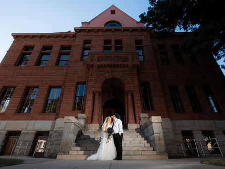Newly married couple posing for courthouse wedding photos at the Old Orange County Courthouse in Santa Ana