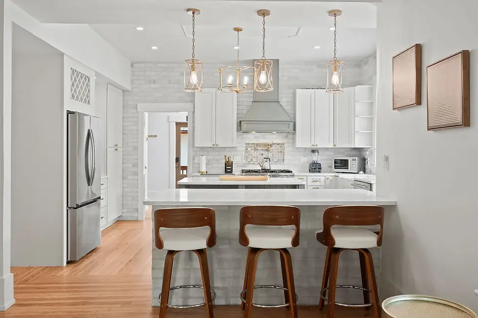 Modern kitchen with white cabinetry, stainless steel appliances, and center island in historic St. Augustine property