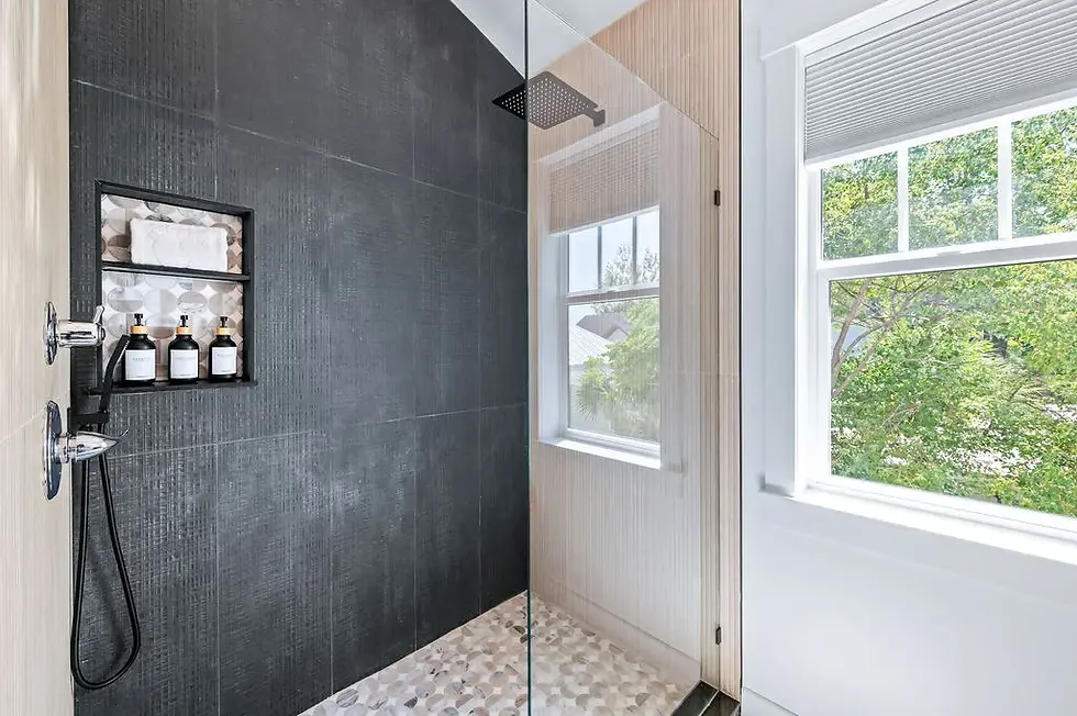 Modern luxury bathroom shower with charcoal tile walls and rainfall showerhead at St Augustine Florida beach house rental