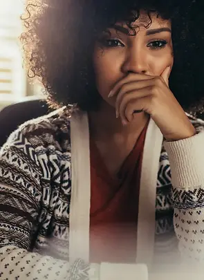 Woman deep in thought with hand near her mouth, symbolizing emotional overwhelm, self-doubt, or the quiet inner struggle of low self-worth.