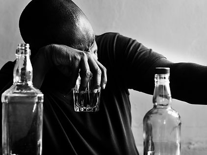 A man holds a glass of alcohol