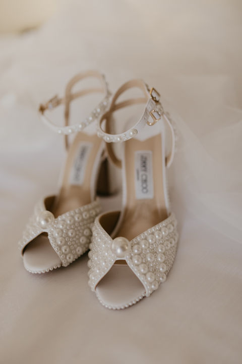 Elegant bridal heels and perfume bottle styled for a luxury Edmonton wedding.