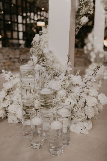 Luxury reception table with roses, candles, and glassware styled for modern weddings.