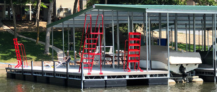 Floating boat dock with red ladders and accessories