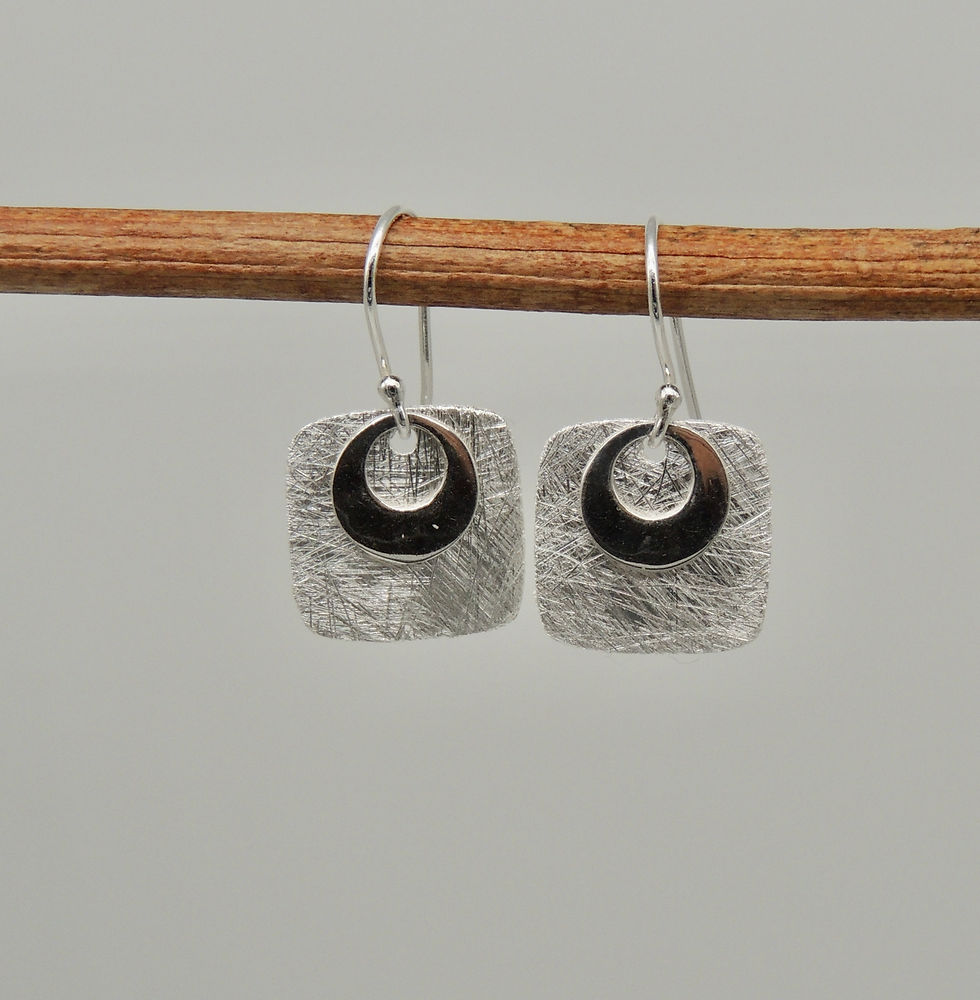 Brushed silver square earrings.