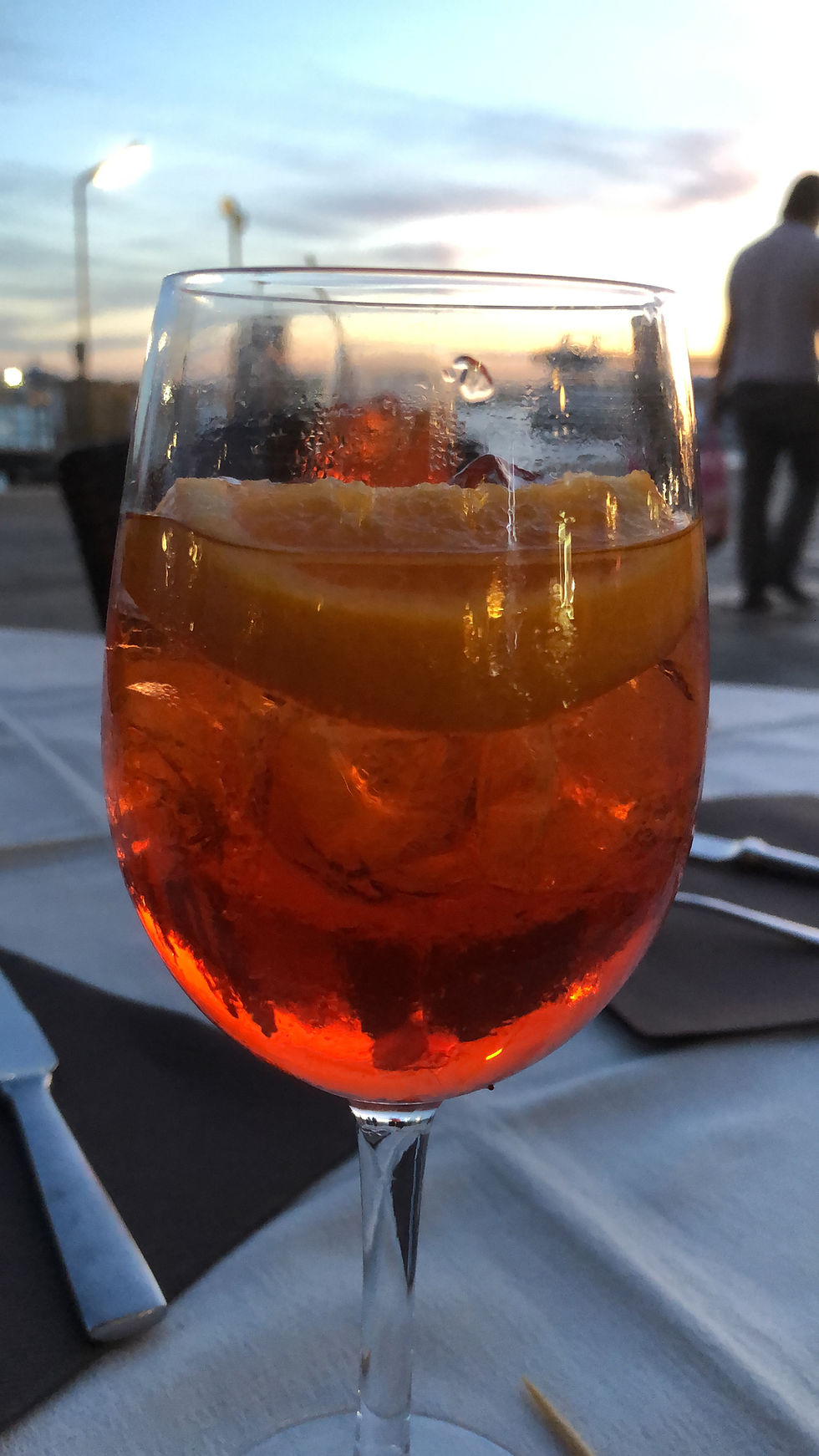 wine glass with aperol and soda on table with Grand Canal in Venice in the background