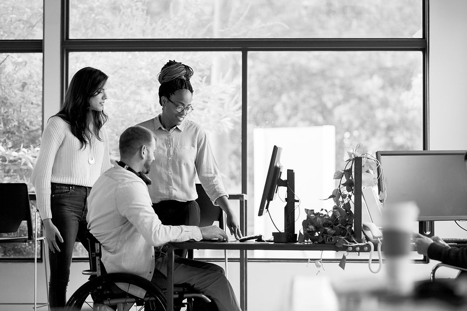 Three co-workers looking at computer