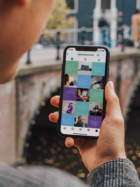 A phone displaying the Alpha Psychiatric Services social media, managed and designed by House of MKTG, showcasing expert social media strategies and engaging content for small businesses.