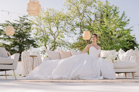bride lounges on couch in the courtyard at her slo outdoor reception