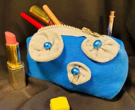 blue upcycled make up bag with flowers and lipstick