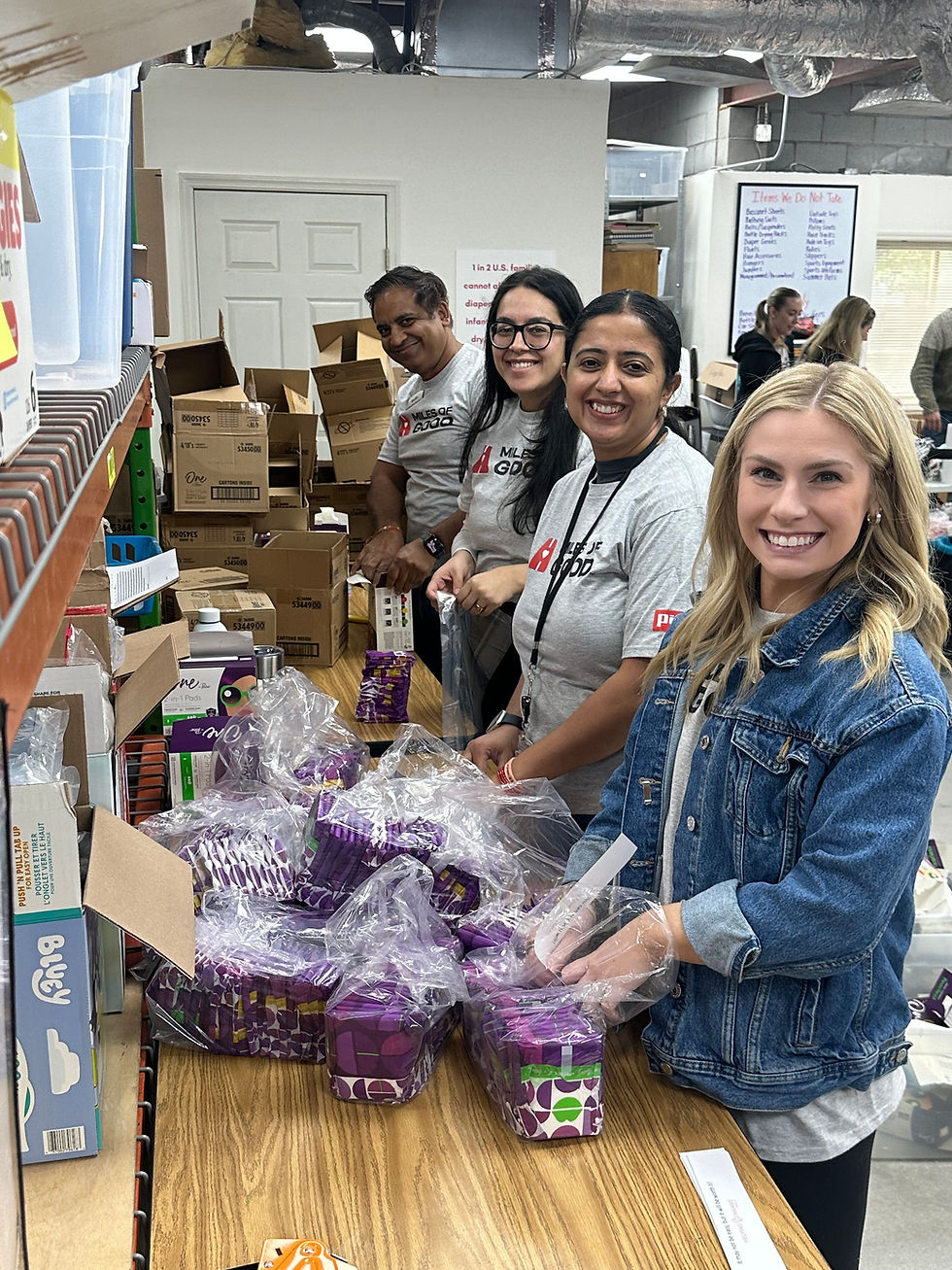 Volunteers packing diaper kits and baby supplies at a Helping Mamas Knoxville kit-making event