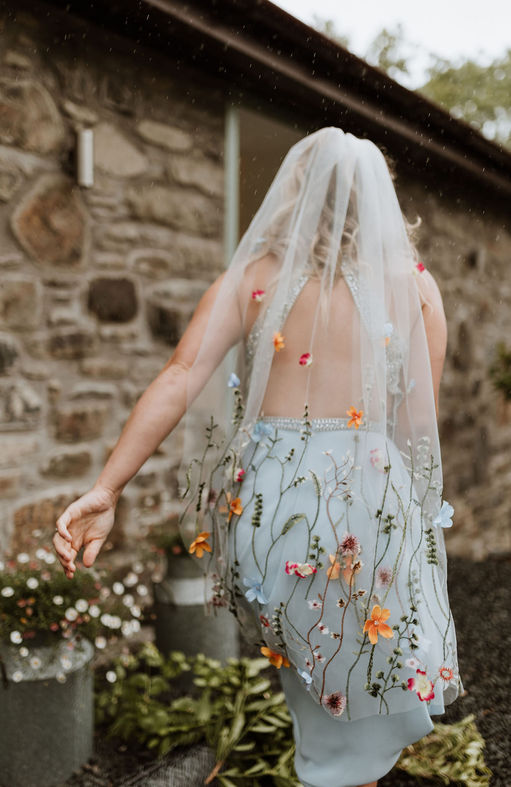 Anastasia floral veil by Adorn Bridal by Ashley
wildmeadow style flowers trailing up a bridal veil scatterd with embelsihed flowers
photographer Pix by Vix