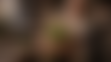 Hildegard of Bingen examines a fresh bundle of centaury in a monastery kitchen, surrounded by pots, herbs, and the calm atmosphere of medieval herbal medicine.