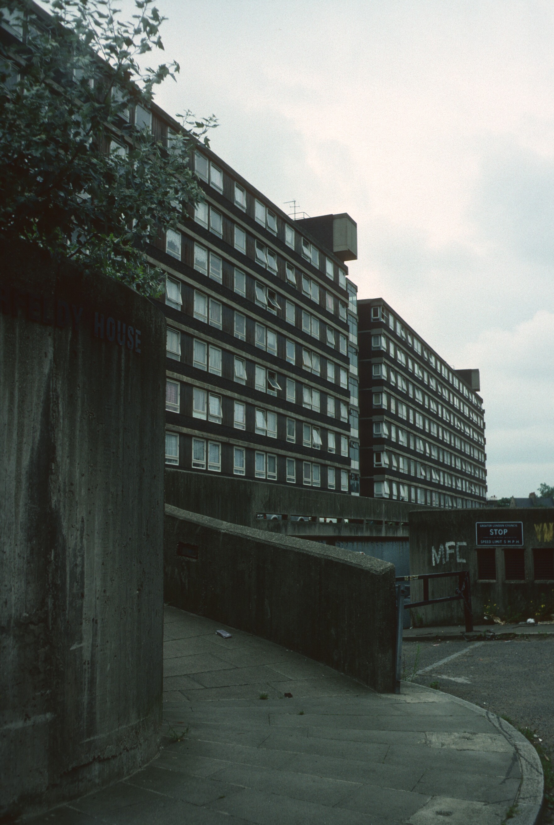 Historic photograph of a multi-storey social housing block and empty walkway in London