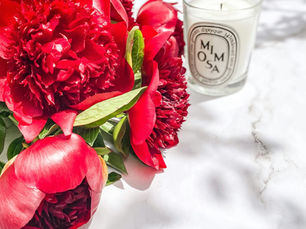 Anniversary gift with red flowers and candle