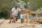 A man and young child at a home construction site.