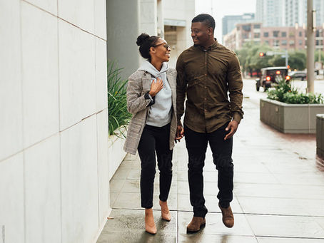 Black couple strolling down the street