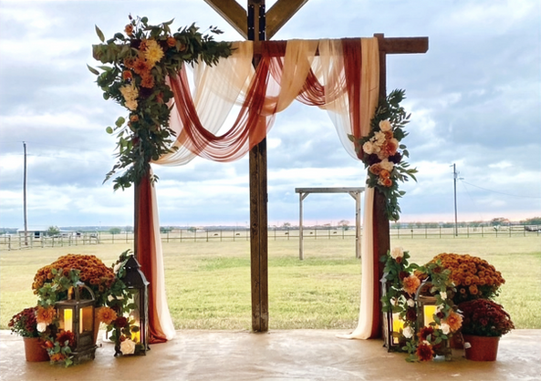 Wedding ceremony arch decorated with flowers at Prosperity Event Venue in North Texas.