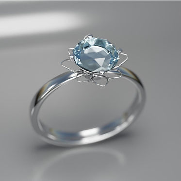 Our ring prototype is 3D modeled, and features a silver band with a blueish gem in the center, framed by metal petals.