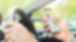 Man-driving-car-with-smart-phone-for-onl