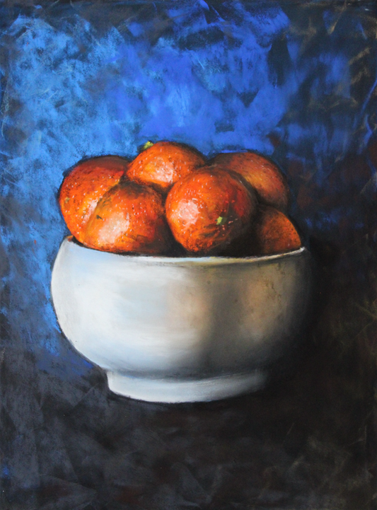 Large white bowl of oranges against a cobalt blue background.
