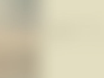 A lone figure stands at an airport window at dusk, looking out. Interior photography for a blog post on the psychology of relocation and identity loss.