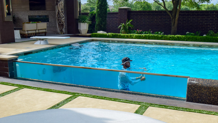 Southlake Modern Pool & Spa with water wall and see thru acryllic wall designed by Mike Farley. This project was featured on Cool Pools of HGTV.
